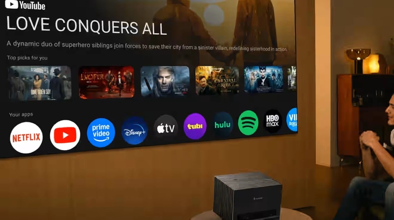 A native Netflix-licensed Google TV projector showing the official Netflix app icon on a massive, high-contrast smart display screen.