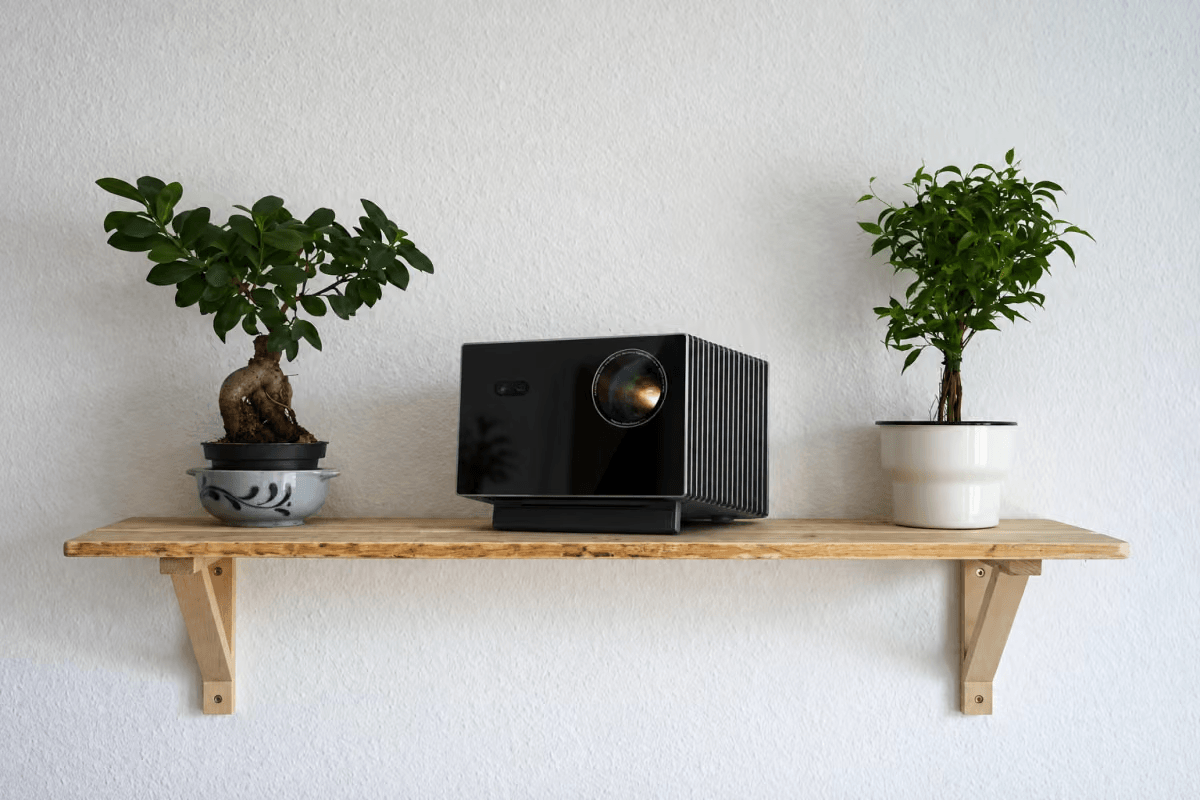 Projector placed on a shelf at the ideal height and distance for home theater setup
