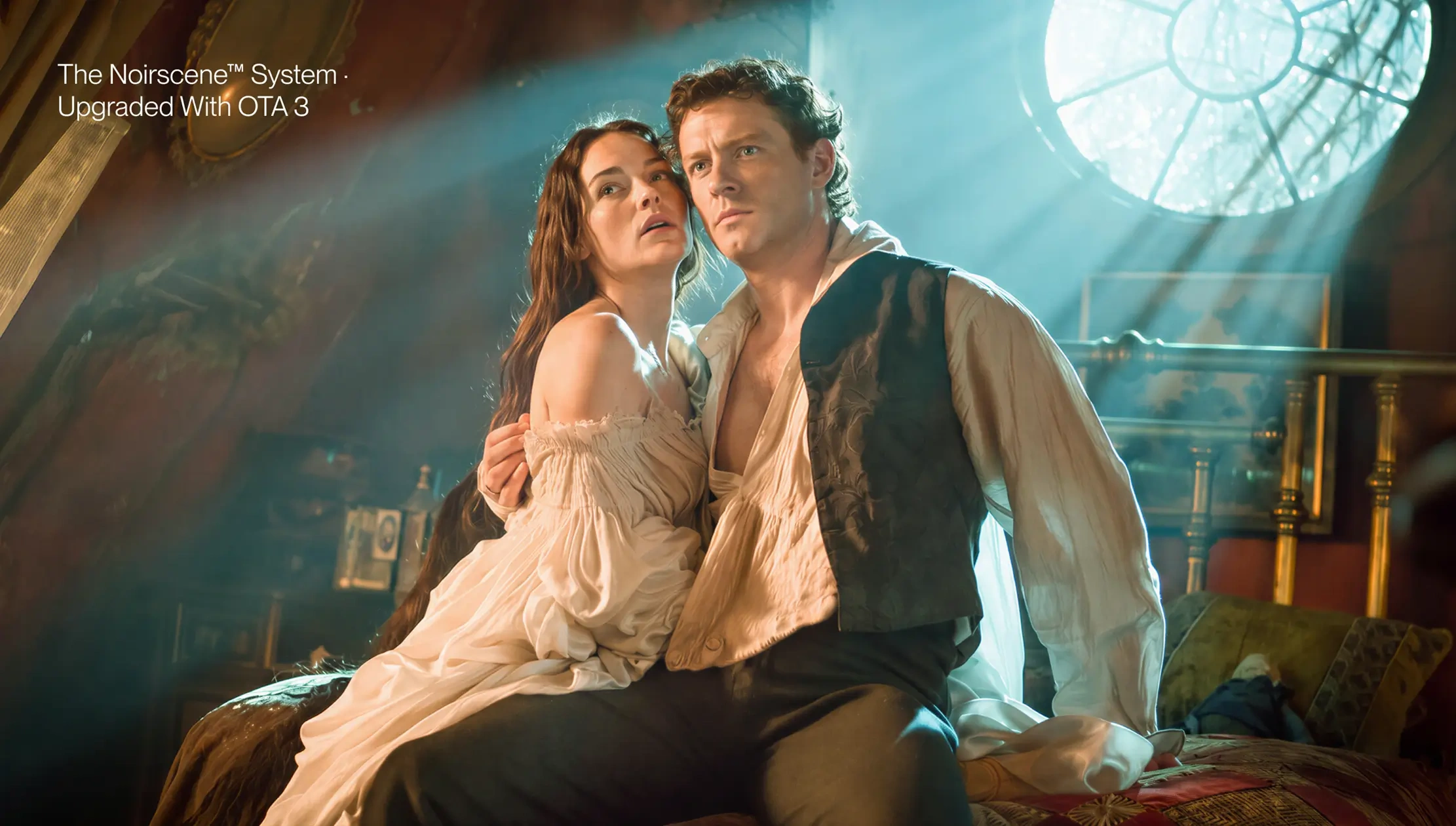 Cinematic movie still of two characters in a historical room with shafts of light and round window, used to illustrate 'The Noirscene™ System . Upgraded With OTA 3' on AWOL Valerion projectors.