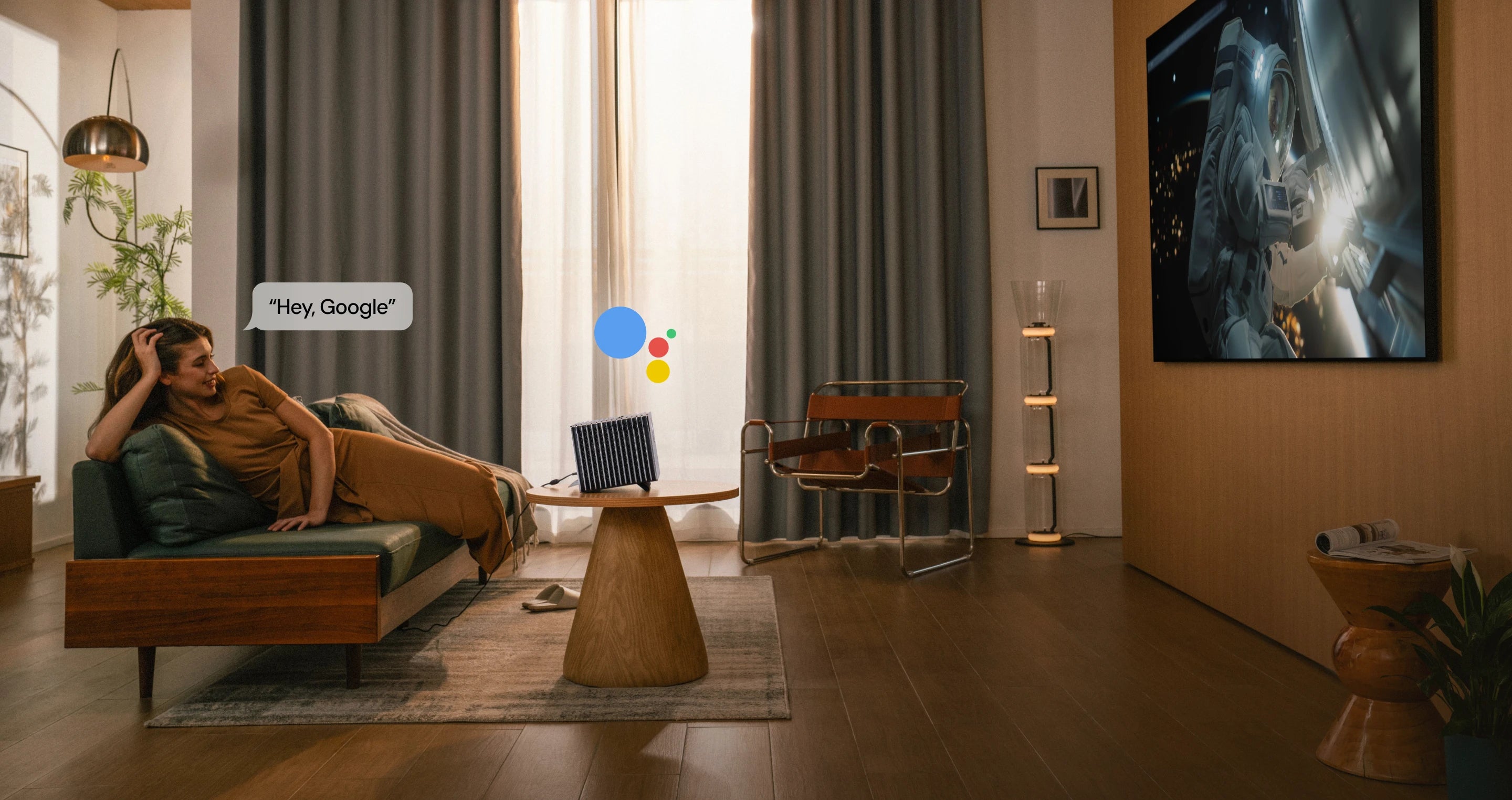 VisionMaster Pro 2 sitting on a table, showing hands-free voice control while a sci-fi scene plays.